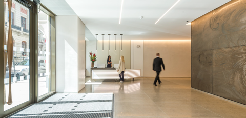 Building reception desk with concrete bronze wall